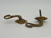 Full view of two antique style swan door handles with mounting plates and spindles, showing overall shape and condition.