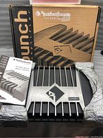 Photo of the Rockford Fosgate Punch 200.4 amplifier with original packaging and protective wrap.