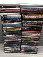 Two large stacks of assorted DVD movies showing a variety of titles including comedies, dramas, action films and thrillers.