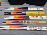Overview of all five pairs of drumsticks showing different colors and branding.