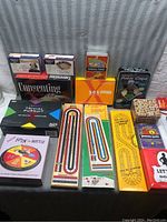 Lot of various adult and classic board games, showing boxes and game boards arranged flat