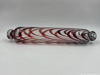 Full side view of the glass rolling pin showing swirl pattern and overall shape