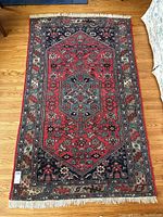 Full view of rug laid flat on hardwood floor