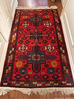 Full-length view of rug laid in hallway showing overall design and condition