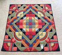Full flat view of the 60x60 inch square quilt showing the complete geometric pattern and color layout