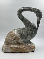 Front side view of soapstone bird sculpture showing curved neck and base
