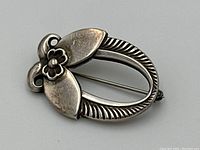 Angled front view showing overall floral design and oval openwork frame