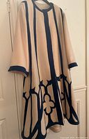 Full front view of coat hanging on hanger