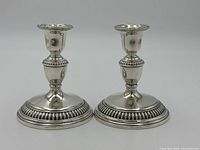 Front view of both candlesticks showing overall design and proportions
