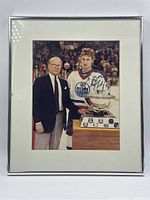 Framed photograph showing entire front, silver frame with white mat