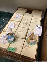 Box containing approximately seventeen Cherished Teddies figurines in original packaging, arranged neatly with two figurines displayed on top.