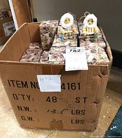Box containing multiple boxed sets of Cherished Teddies hanging ornaments.
