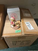 Cherished Teddies Wendell figure on cardboard box with original box in background, showing overall lot and packaging.