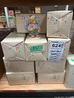 Stack of 24 original boxes with one Cherished Teddies Canada Preston figure displayed on top