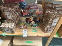 Full view of Cherished Teddies In Motion set on shelf with all vehicles and garage display, surrounded by multiple original boxes.