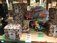 Photo showing the display of teddy bear figurines on a two-level garage structure with backdrop labelled 'Teddies In Motion'