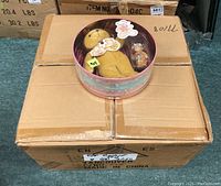 Boxed Cherished Teddies Gift Sets stacked on cardboard boxes, showing the circular windowed packaging.