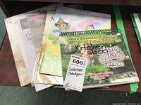 Eight Precious Moments collectibles catalogs arranged in a fan with visible front covers showing figurine images and logo