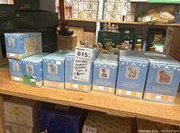Photo of the lot showing 8 original boxed Precious Moments Birthday Train figures lined up with tags labeled '3 pcs' and '8 pcs' visible on boxes.