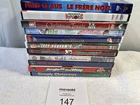 Stack of 11 assorted Christmas DVDs showing titles and states of packaging.
