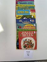 All seven vintage read along record books stacked showing front covers for identification.