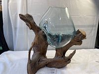 Frontal photo of decorative glass bowl on natural teak wood base showing the glass bowl molded and heated to fit wood.