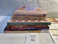 Stack of seven quilting books including The Quilter's Stitch Bible at top