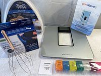Image showing all items including large pill organizer, elbow wrap packaging, leg pillow packaging, emWave 2 box, metal head scratcher, and AccuWeight scale on white background.