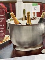 Photo of the large ice bucket in its retail box showing bottles chilled with ice inside the bucket.