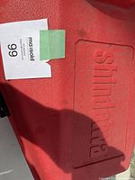 Red plastic case lid embossed with 'Shindaiwa' and MaxSold sticker #99