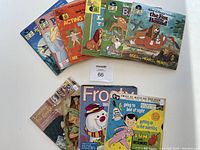 Books and records arranged on a white surface showing colorful illustrated read along books with corresponding 45 RPM records visible in paper sleeves.