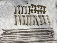 Full layout of all keys and chains on white towel showing quantity and variety of items