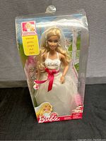 Barbie bride doll in original packaging showing full front view with bridal gown and red ribbon sash.
