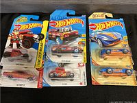 Six Hot Wheels cars in original packaging displayed showing front and packaging details including 50th Anniversary labels.