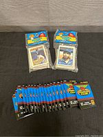 Two sealed Topps Score Board 50-card packs and multiple sealed Topps Stadium Club 1991 Second Series card packs arranged on a surface.