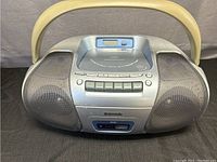 Front and top view of Panasonic RX-D27 boombox closed, showing silver body with speakers and CD player on top.