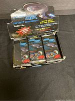 Original box for Star Trek The Next Generation Stardisk Coins Launch Edition. Box shows wear and partial damage but contains unopened packs.
