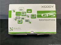 Original white and green XGODY GPS navigation box with product logo and branding.