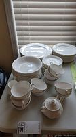 Full set of Hankook china including plates, bowls, cups, sugar bowl, and creamer arranged on table.