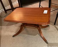 Top view of the wood side table showing rectangular beveled edge top and warm brown finish.