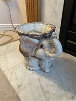 Front side view of ceramic elephant planter showing detailed face and ears.