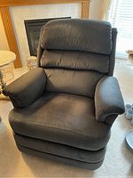 Front view of the La-Z-Boy recliner chair showing padded armrests, cushioned seat and back, and dark gray fabric upholstery.