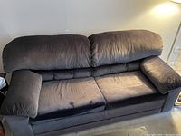 Front view of two-seat dark charcoal sofa bed with plush cushions