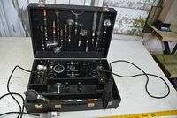 Open carrying case showing control unit, foam inserts, power cord and probes