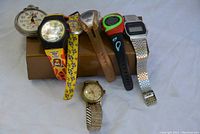 Full assortment of 5 watches arranged together showing varied styles and bands