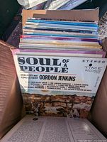 Box with vinyl records showing 'Soul of a People' album by Gordon Jenkins on top