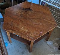 Top view showing hexagonal wooden surface with scratches, stains, and wear marks