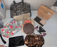 Overview of assorted tote bags and purses including bamboo handbag, lace tote, striped floral bag, and metallic sequin purse