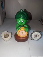 Three clocks: heart-shaped Lenox clock, Lenox Talking Sprout alarm clock, vintage floral clock