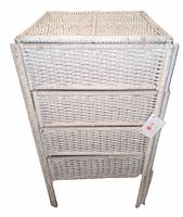Front view of white vintage wicker stand showing woven wicker construction and legs.